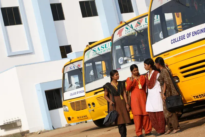 Students beside a college bus
