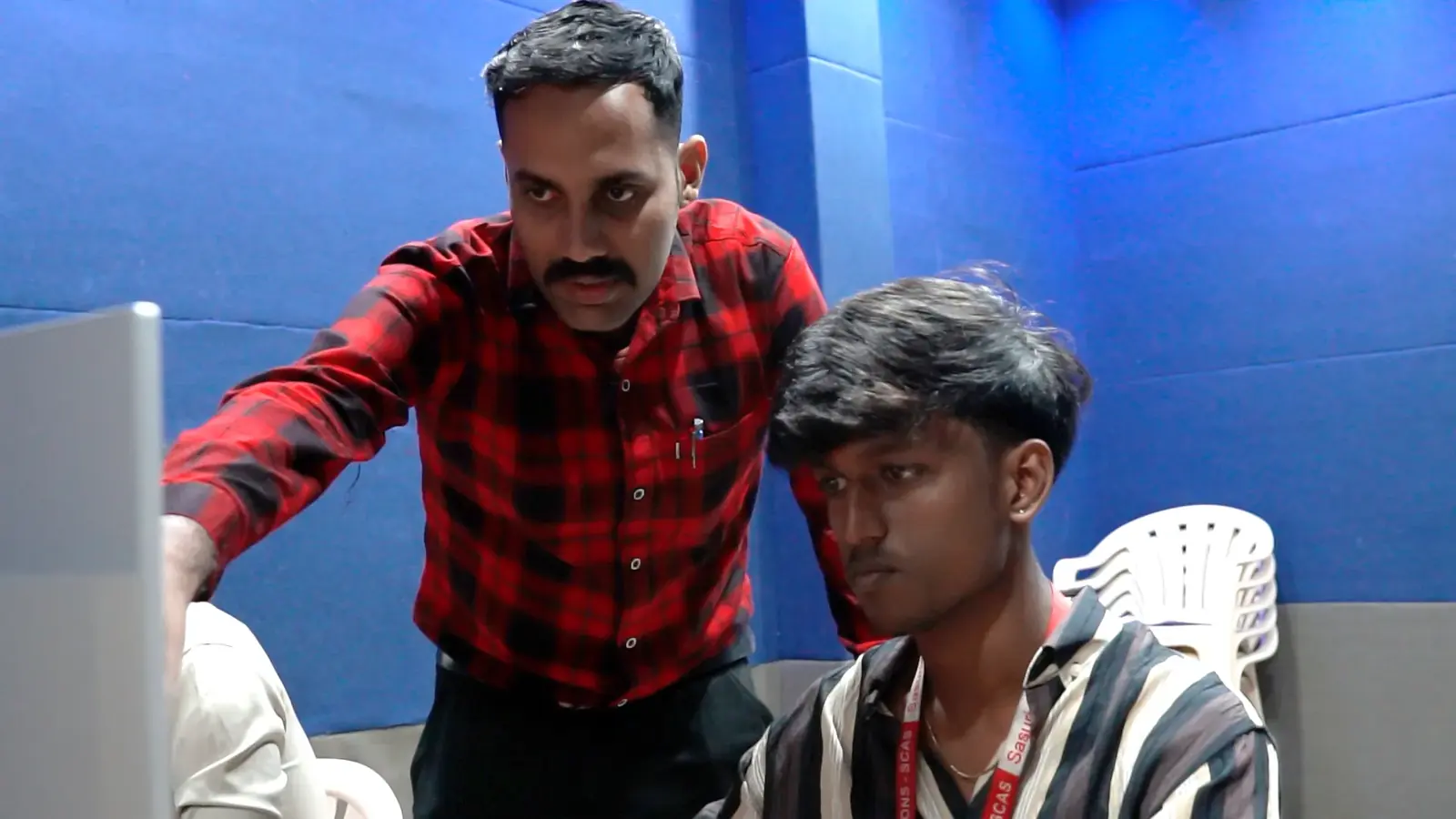 A faculty member guiding a student in the lab