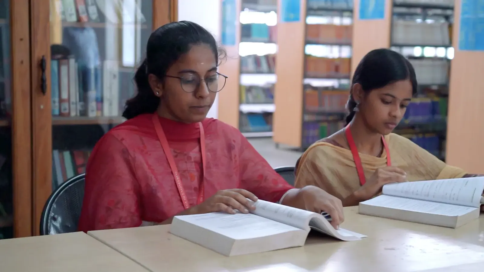 Two students reading in the library